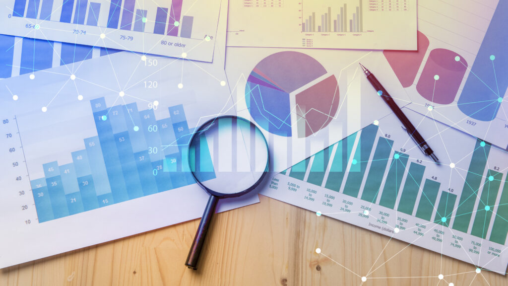 Graphs-and-Charts-on-Table-With-Magnifying-Glass